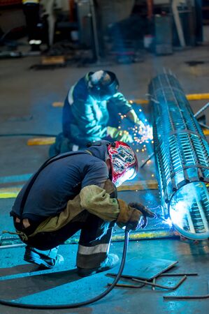 Tyumen, Russia - September 4, 2019: Mostootryad-36 Factory. Welders in action with bright sparksのeditorial素材