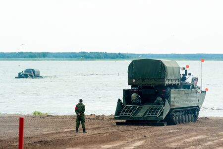 Tyumen, Russia - August 10, 2019: International Army Games. Engineering Formula contest. Equipment transportation across a water obstacle tracked amphibious carrier PTSのeditorial素材