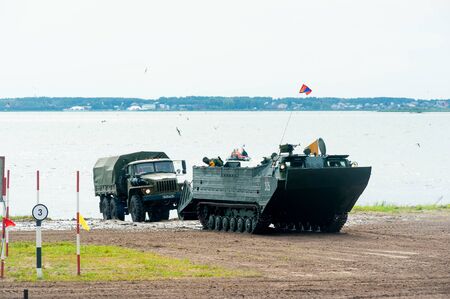Tyumen, Russia - August 10, 2019: International Army Games. Engineering Formula contest. Large pontoon boats transporting truckのeditorial素材