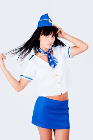 Attractive young stewardess smiles over white backgroundの写真素材