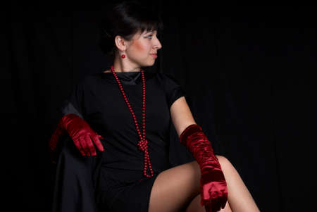 Young woman at studio at black background