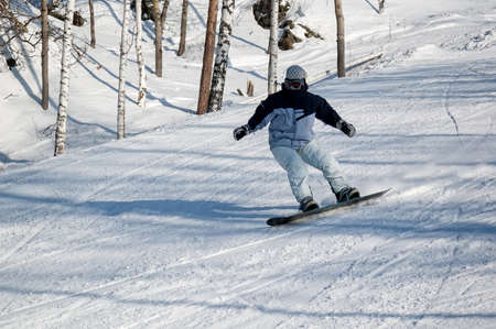 Kirovgrad, Russia - February 26, 2005: Female snowboarder on the slopes. Ezhovaya skiing center