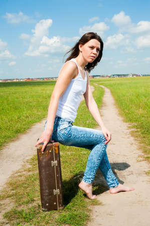Attractive sexy woman with a suitcase outdoor. portrait of a brunette girlの写真素材