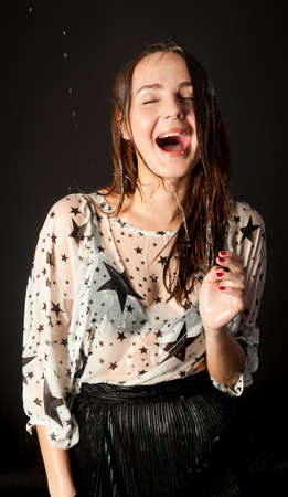 Young beautiful woman in wet blouse criesの写真素材