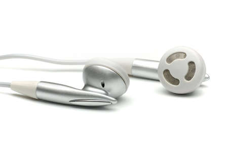 Silver earphones isolated on whiteの写真素材