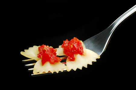 Italian pasta and tomato sauce isolated over blackの写真素材