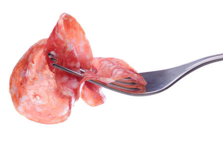 Closeup of salami on fork isolated on white backgroundの写真素材