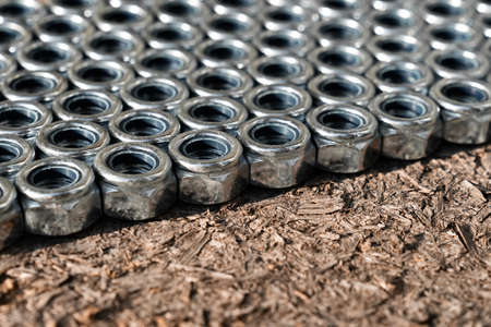 Heap of stainless screw-nuts on wooden background. Background. High quality photoの写真素材