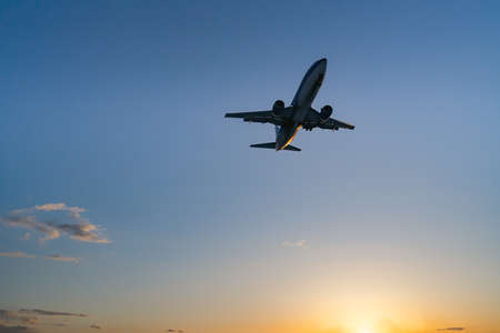 The plane comes in for landing at sunset. High quality photoの写真素材