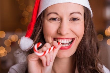 Christmas fun, young smiling woman over bokeh backgroundの写真素材
