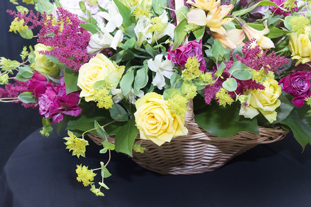 Beautiful bouquet in a basket close upの写真素材