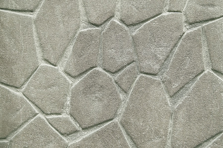 Old grey stone wall background texture close up