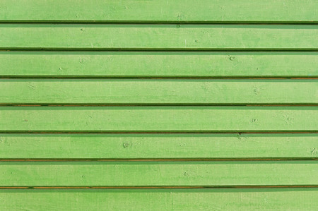 Old green wooden fence background texture close upの写真素材