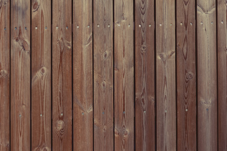 Old brown wooden fence background texture close up