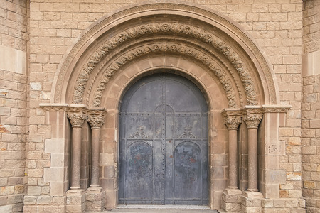 Old monastery door with arch in Barcelonaの写真素材