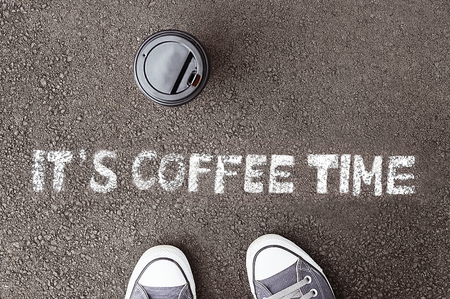 Chalk paint of words - IT'S COFFEE TIME - on asphalt の写真素材