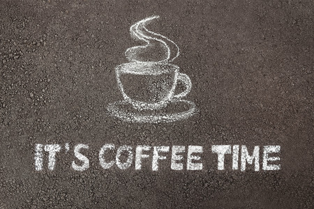 Chalk paint of cup of coffee and words - IT'S COFFEE TIME - on asphaltの写真素材