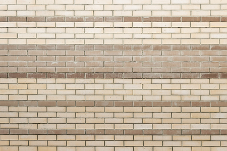 Old beige brick wall background texture close upの写真素材