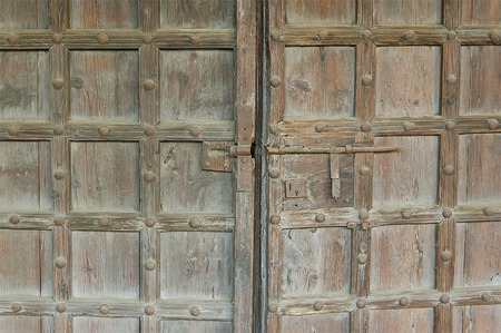 Old wooden door with metal elements close upの写真素材