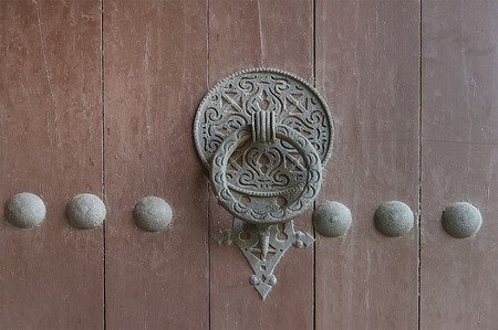 Old wooden door with metal elements close upの写真素材