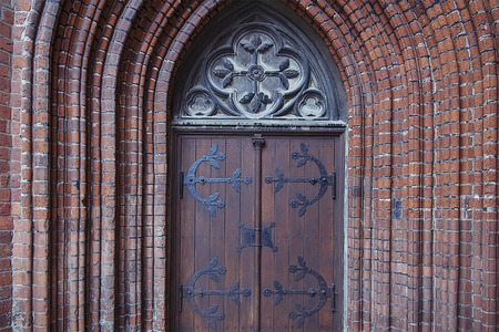 Old wooden door with metal elements close upの写真素材