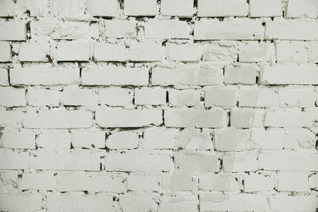 Old white painted brick wall background texture close upの写真素材