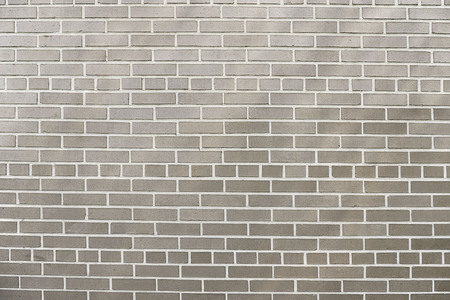 Old grey brick wall background texture close upの写真素材