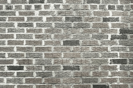 Old grey brick wall background texture close up
