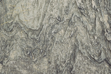 Grey granite rock background texture close up
