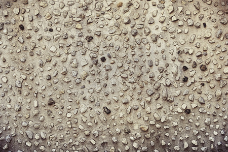 Old brown stone wall background texture close up