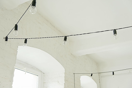 Whte brick interior with black light bulbs