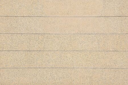 Old beige stone wall background texture close up