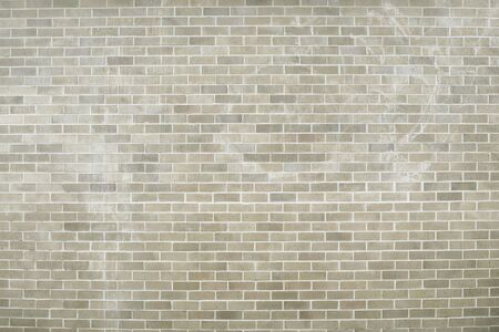 Old grey brick wall background texture close up