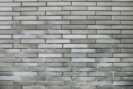 Old grey brick wall background texture close upの写真素材