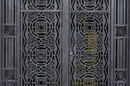 Old black metal door background texture close up