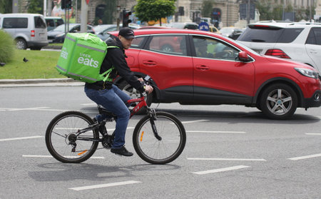 Bucharest, Romania - June 10, 2018: An Uber Eats courier delivers food in Bucharest, Romania.のeditorial素材