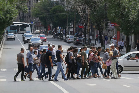 Bucharest, Romania - July 11, 2018: Pedestrians cross the street on Regina Elisabeta Boulevard in Bucharest, Romania.のeditorial素材