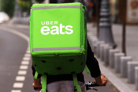 Bucharest, Romania - August 01, 2018: An Uber Eats courier delivers food in Bucharest, Romania.のeditorial素材