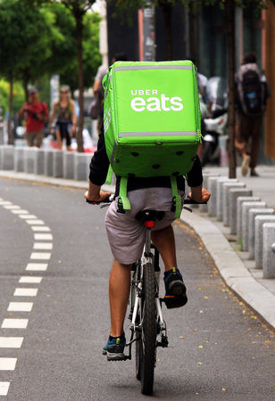 Bucharest, Romania - August 01, 2018: An Uber Eats courier delivers food in Bucharest, Romania.のeditorial素材