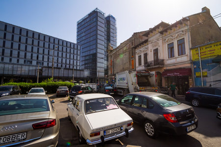 Bucharest, Romania - July 07, 2019: Few old degraded buildings are seen near new buildings in a zone where old and new buildings are mixed by rising real estate market on Grivitei street in Bucharest.のeditorial素材