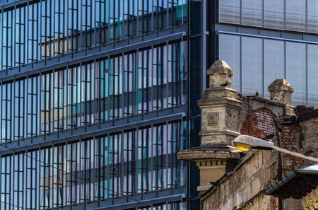 Bucharest, Romania - July 07, 2019: Few old degraded buildings are seen near new buildings in a zone where old and new buildings are mixed by rising real estate market on Grivitei street in Bucharest.のeditorial素材