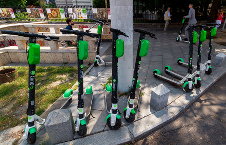 Bucharest, Romania - July 30, 2019: Several Lime-S Electric Scooters are parked on a sidewalk in Bucharest. This image is for editorial use only.のeditorial素材
