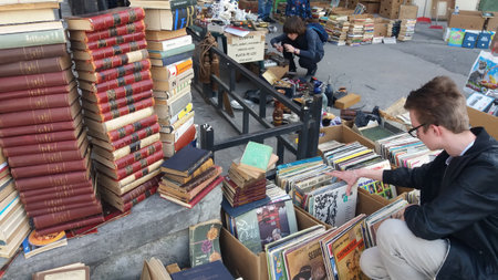 Bucharest, Romania - March 25, 2018: Young people buy books from a street antique in downtown Bucharest, Romania.のeditorial素材