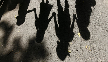 Bucharest, Romania - July 01, 2019: The shadow of a horo dance made by children is seen at the official opening of the summer kindergartens in Bucharest. This image is for editorial use only.のeditorial素材