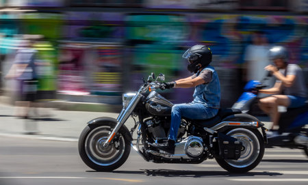 Bucharest, Romania - June 10, 2018: A Harley-Davidson Fat Boy chopper motorcycle passes with speed  through the Gheorghe Magheru Boulevard in Bucharest, Romania. This footage is for editorial use onlyのeditorial素材
