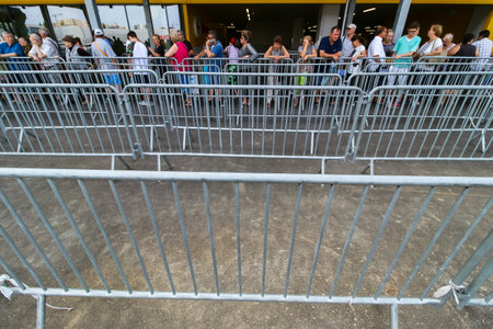 Bucharest, Romania - June 24, 2019: People are waiting in a fencing lane area to enter, in the opening day, in the new IKEA Pallady store, which is the second in Bucharest and elsewhere in Romania.のeditorial素材