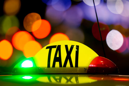 Bucharest, Romania - January 02, 2019: Taxi at night with lights signal system works. Yellow cab in Bucharest, Romania.のeditorial素材