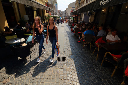 Bucharest, Romania - August 23, 2018: Old-style streets with houses with a beautiful architecture where bars, pubs, coffee shops, restaurants, terraces or even discos are opened as an attraction for tourists in the old city of Bucharest in Romania.のeditorial素材