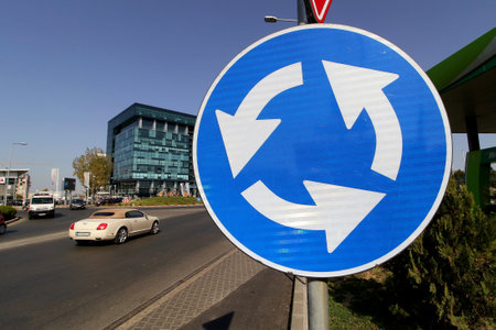 Bucharest, Romania - October 17, 2018: A roundabout traffic sign, at an intersection in the Pipera neighborhood, in Bucharest.のeditorial素材