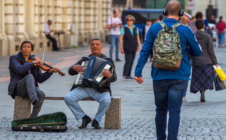 Bucharest, Romania - May 02, 2019: Two Gypsy singers play on the Lipscani street in the old city of Bucharest, Romania. This image is for editorial use only.のeditorial素材